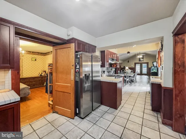 a kitchen with stainless steel appliances granite countertop a refrigerator and a sink