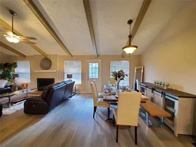 a living room with fireplace furniture and a wooden floor