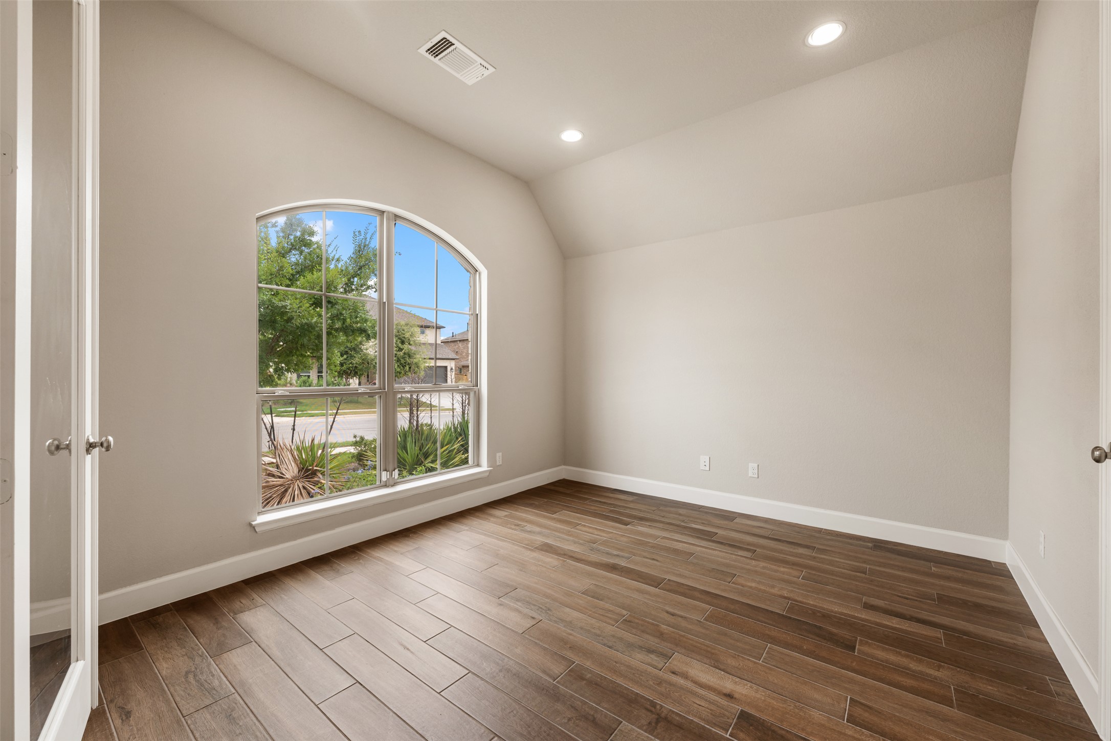 104 Anejo Bluff Georgetown, TX 78628 - Photo 4 of 40 an empty room with wooden floor and windows
