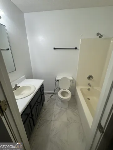 a bathroom with a sink a toilet and bathtub