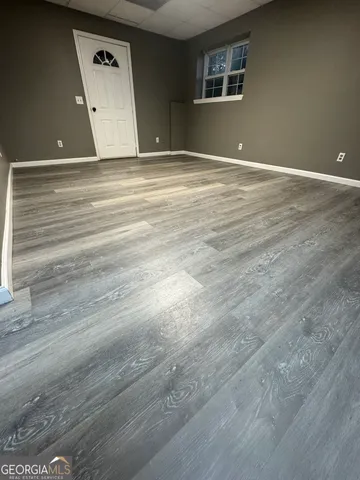 a view of a room with wooden floor