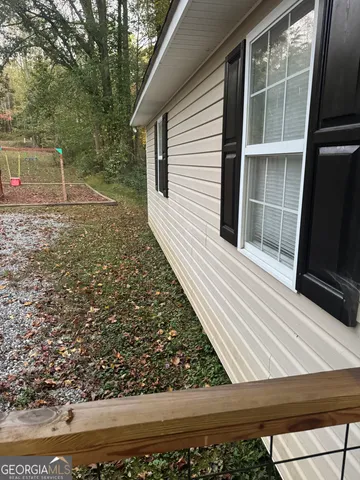 a view of backyard with wooden floor and a potted plant