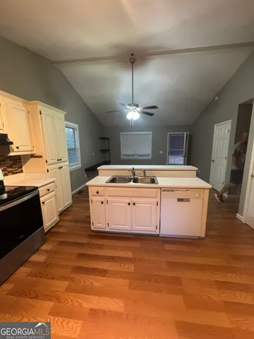 a kitchen with a stove top oven and cabinets
