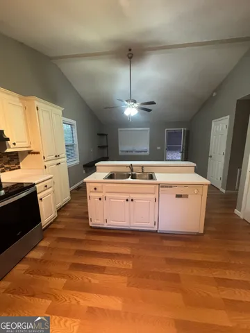 a kitchen with a stove double vanity and window