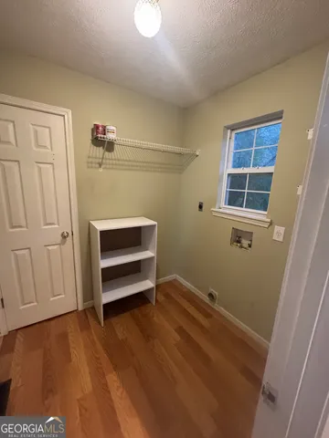 a view of room with hardwood floor and window