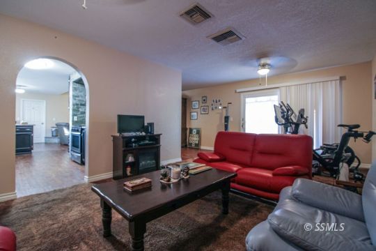 900 North Sierra View Street Ridgecrest, CA 93555 - Photo 5 of 42 a living room with furniture and a flat screen tv
