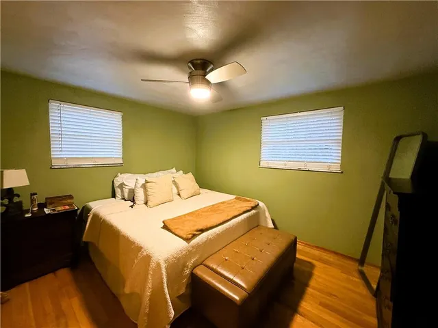 a bedroom with a bed and a mirror