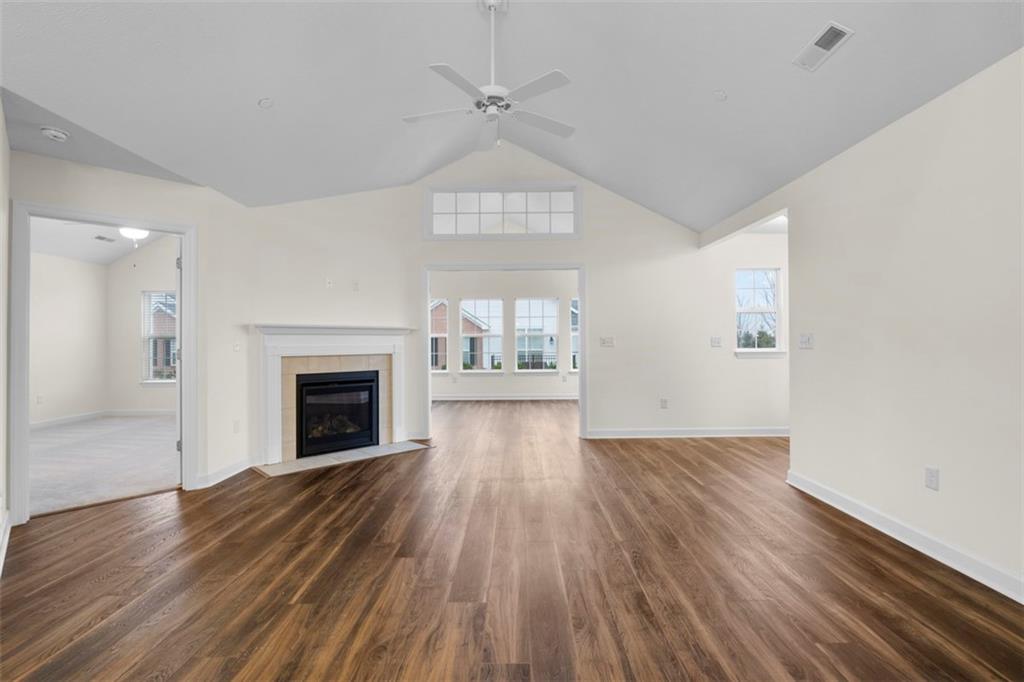 1024 Tilly Drive Valencia, PA 16059 - Photo 13 of 35 an empty room with wooden floor fireplace and windows