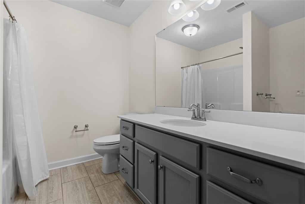 1024 Tilly Drive Valencia, PA 16059 - Photo 22 of 35 a bathroom with a granite countertop sink a toilet and a mirror