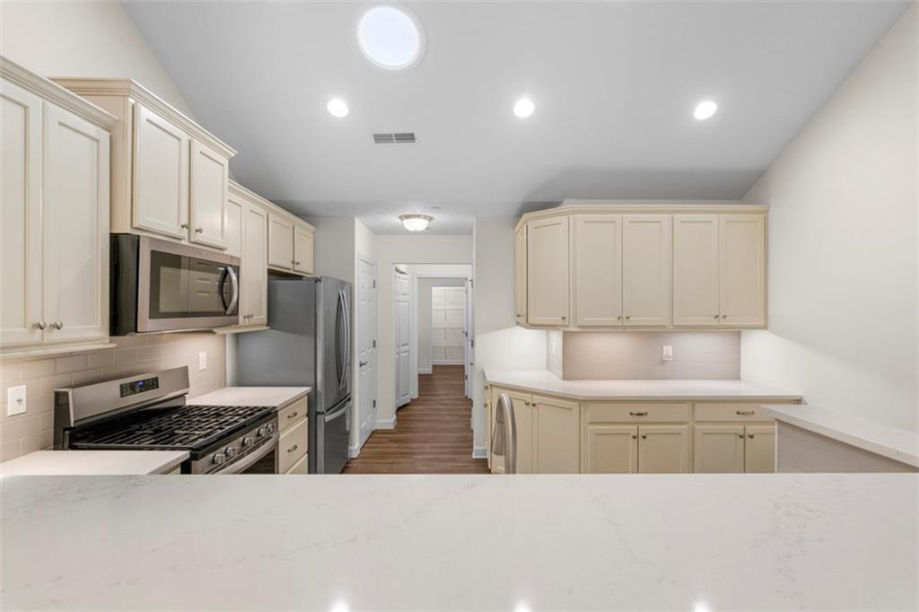 1024 Tilly Drive Valencia, PA 16059 - Photo 9 of 35 a kitchen with stainless steel appliances a stove a sink a microwave a refrigerator and cabinets