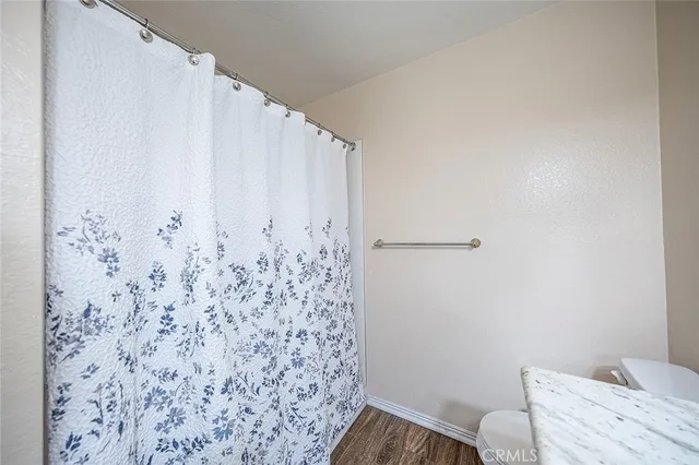 a bathroom with a shower curtain and a toilet