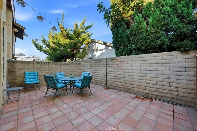 a view of patio with table and chairs and potted plants