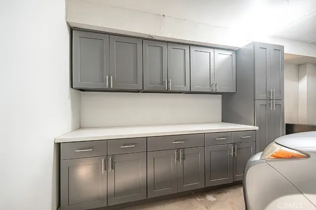 a kitchen with cabinets and stainless steel appliances