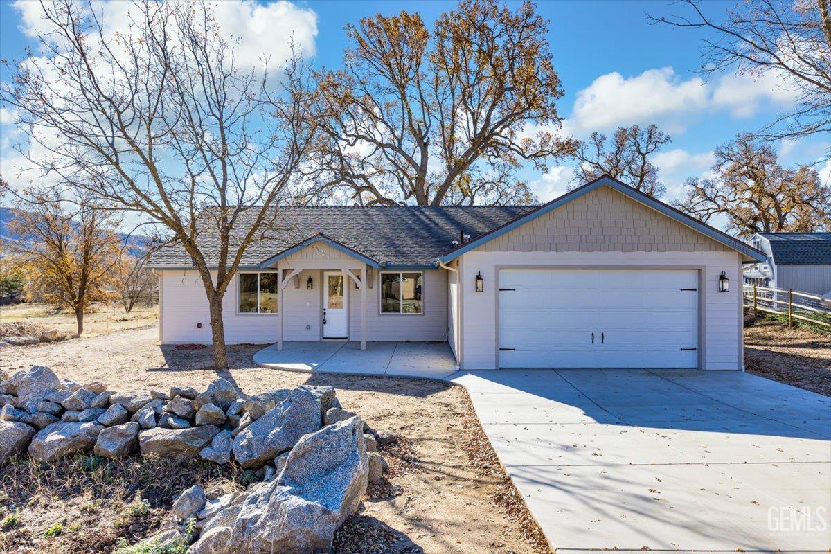 a front view of a house with a yard covered with snow