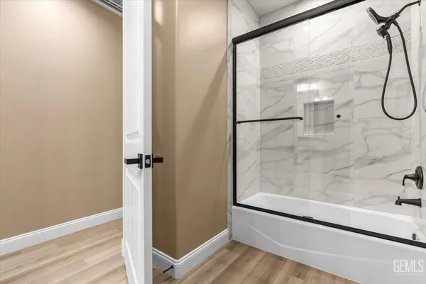a bathroom with a glass shower door
