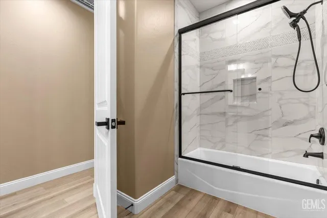 a bathroom with a glass shower door