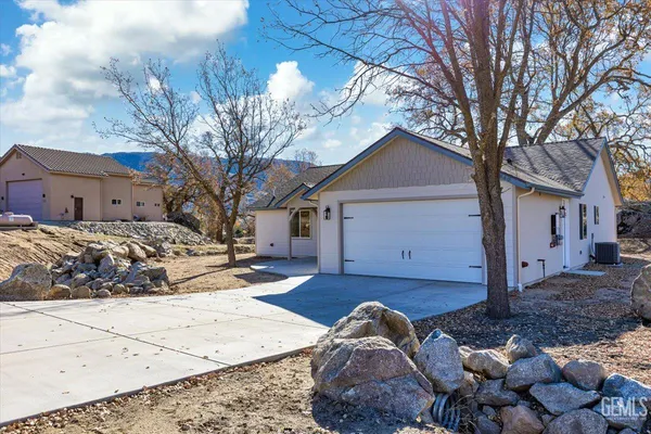 a front view of a house with a yard covered in snow