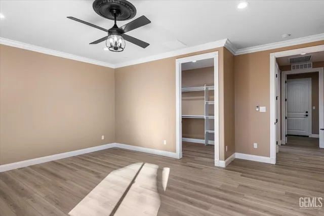 a view of an empty room and wooden floor