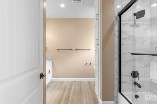 a bathroom with a glass shower door