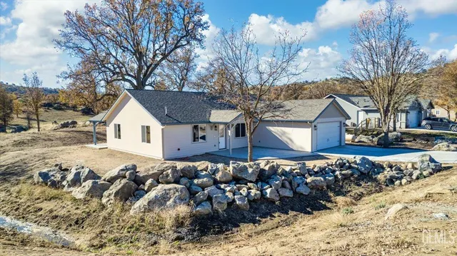 a view of a house with a yard covered in snow