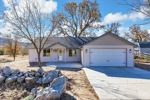 a front view of a house with a yard covered with snow