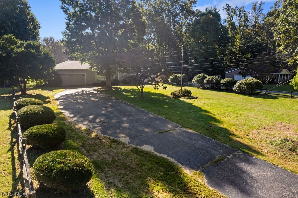 11363 Dupont Road Washington, WV 26181 - Photo 31 of 42 Single-story residence featuring a two-car garage, mature trees, and a sloped lawn