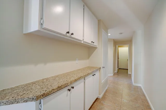 a view of a kitchen with marble countertop