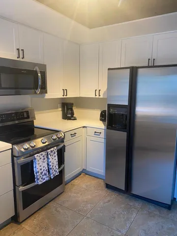 a kitchen with a stove and a refrigerator
