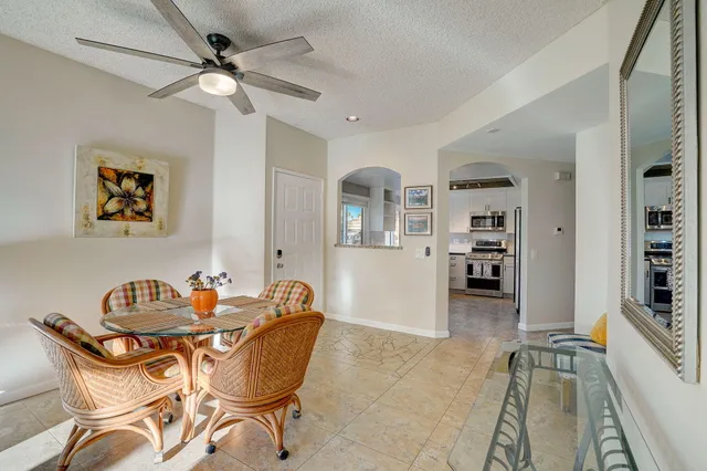 a living room with furniture a rug and a chandelier
