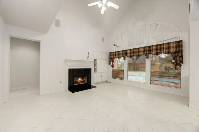 a view of fireplace with an empty room