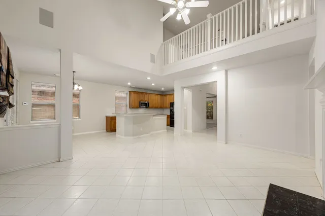a view of a hallway with chandelier and entryway