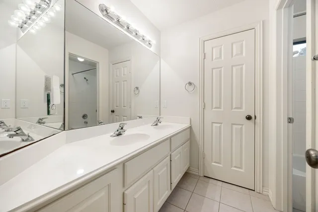 a bathroom with a double vanity sink mirror and