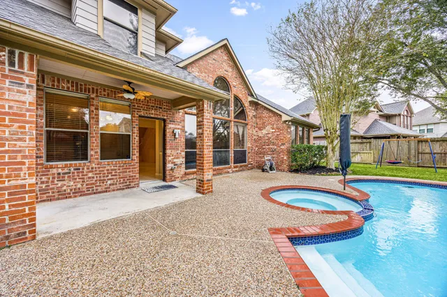 a view of a house with swimming pool and sitting area