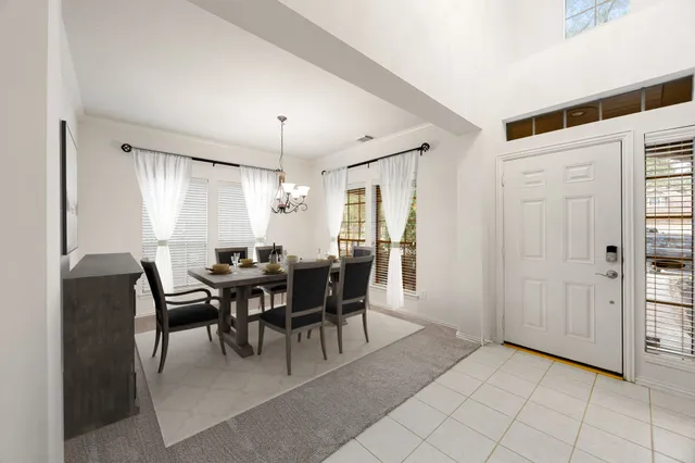 a view of a dining room with furniture and chandelier