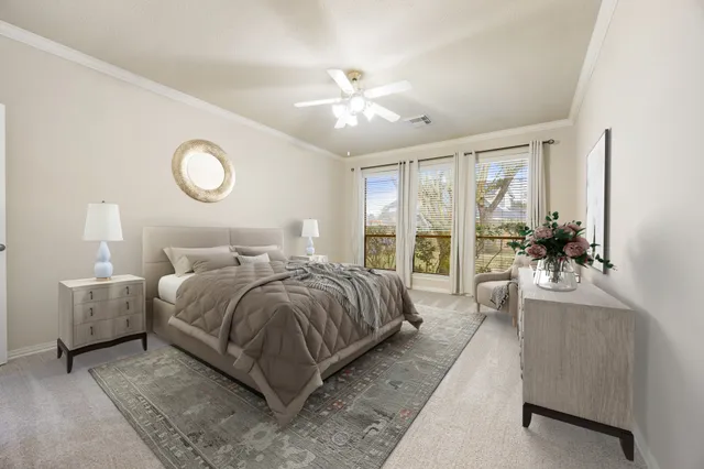 a bedroom with a large bed and a chandelier