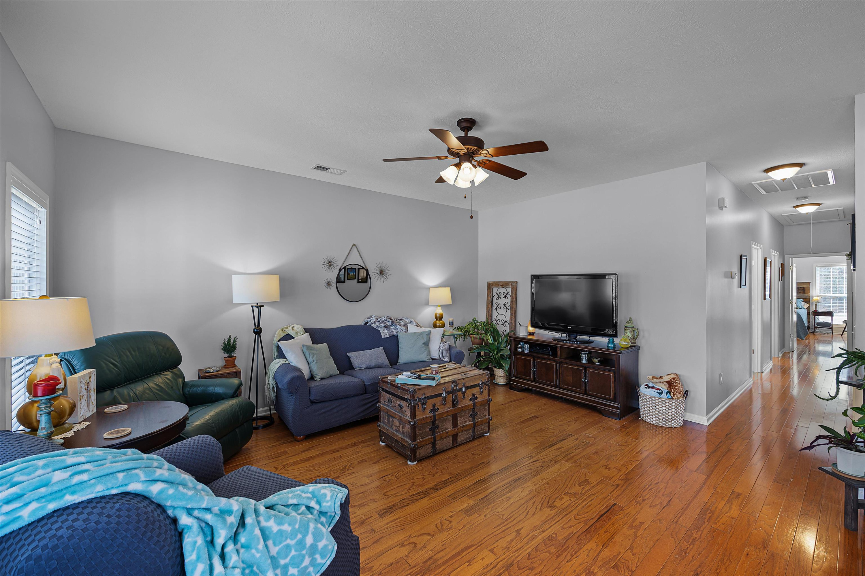 2305 Mockingbird Road Medon, TN 38356 - Photo 11 of 27 a living room with furniture a flat screen tv and wooden floor