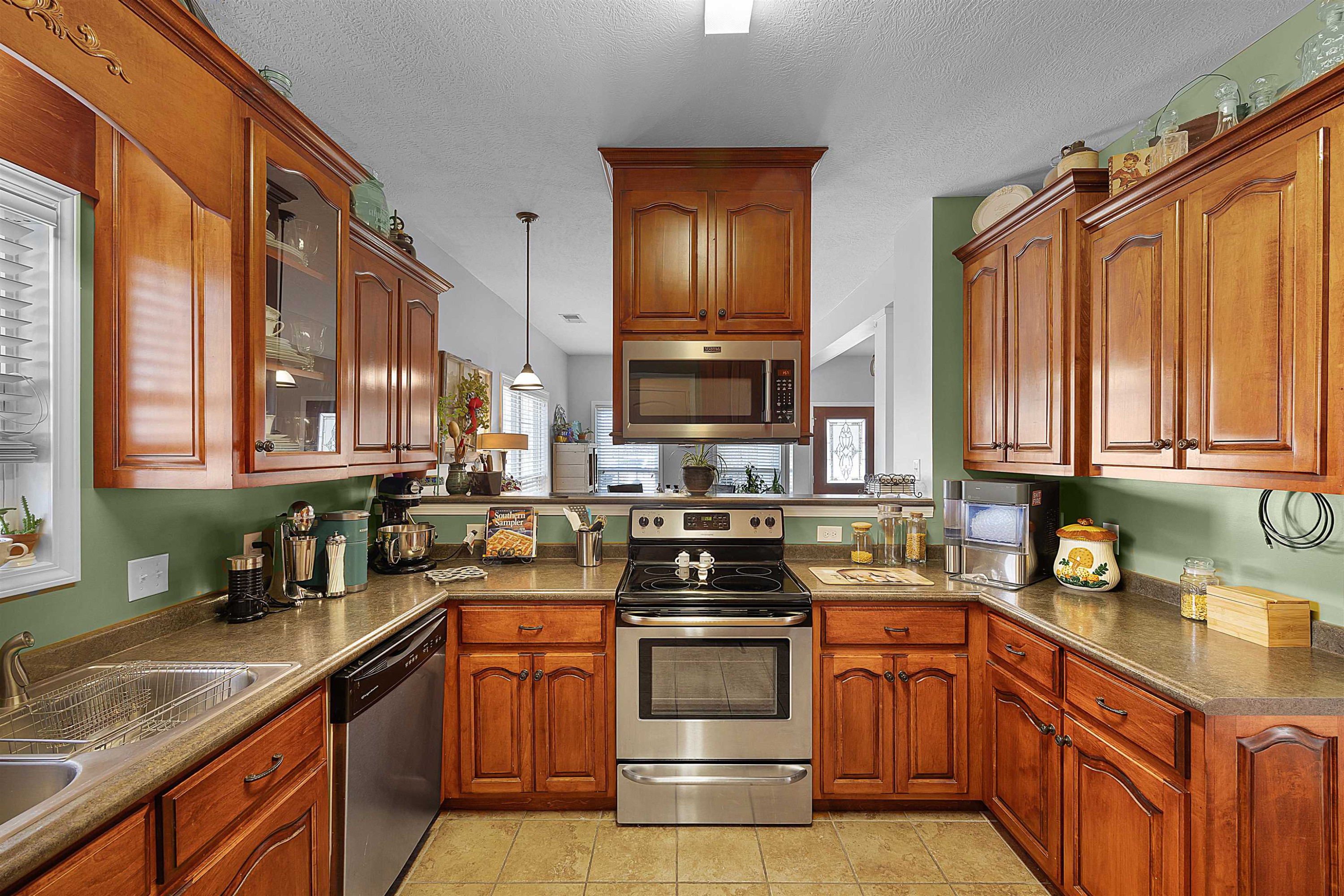 2305 Mockingbird Road Medon, TN 38356 - Photo 21 of 27 a kitchen with stainless steel appliances granite countertop a stove a sink dishwasher and a microwave oven with large cabinets