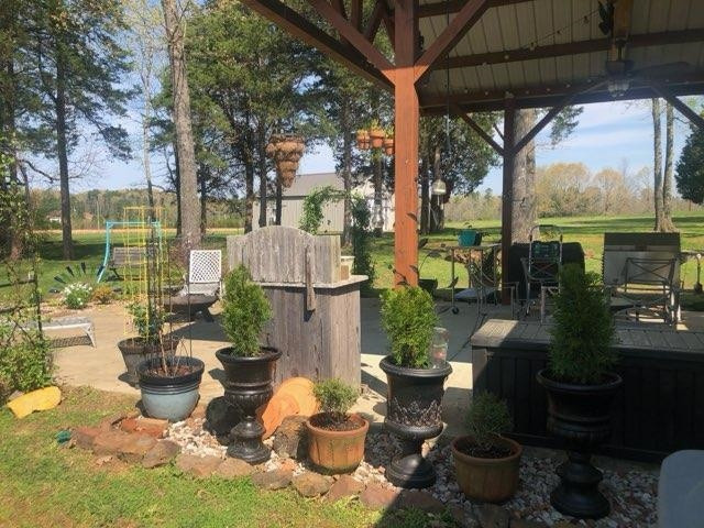 2305 Mockingbird Road Medon, TN 38356 - Photo 8 of 27 a view of a patio with couches chairs and potted plants