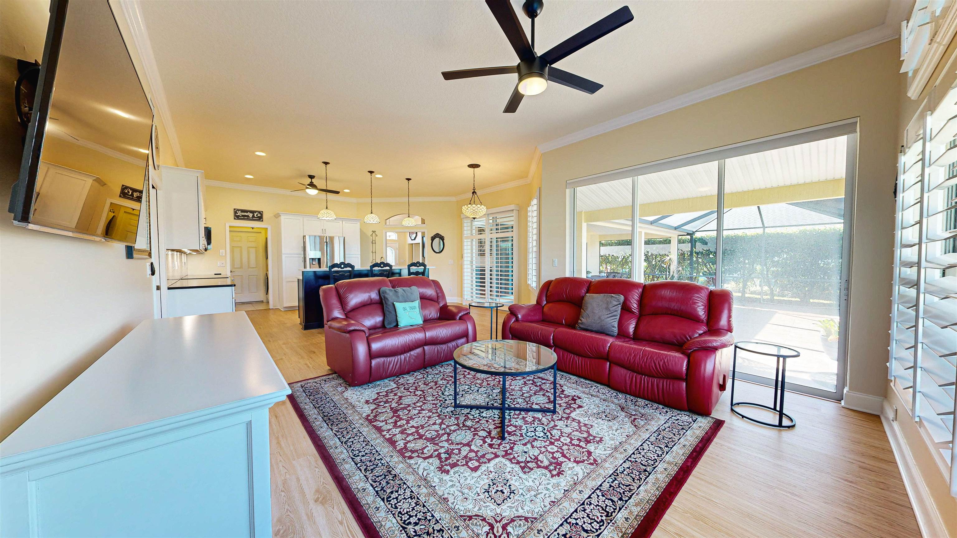 337 San Nicolas Way St. Augustine, FL 32080 - Photo 13 of 23 a living room with furniture floor to ceiling window and a flat screen tv
