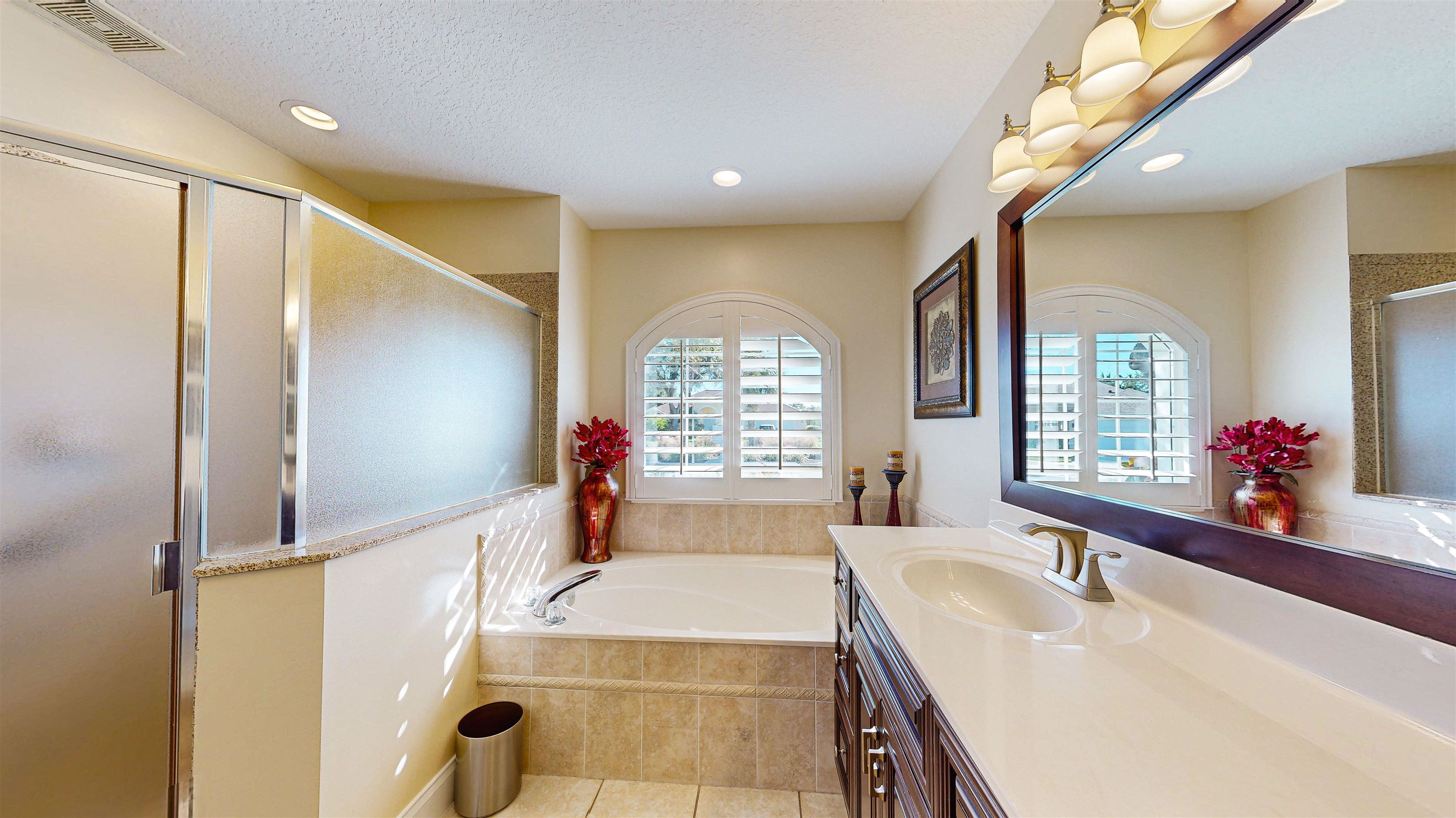 337 San Nicolas Way St. Augustine, FL 32080 - Photo 19 of 23 a spacious bathroom with a tub sink and mirror
