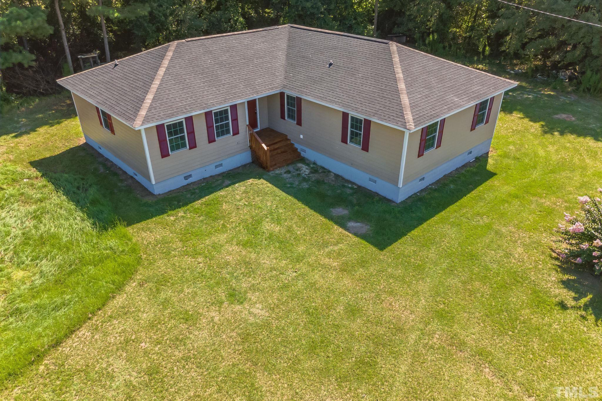 a aerial view of a house with a yard