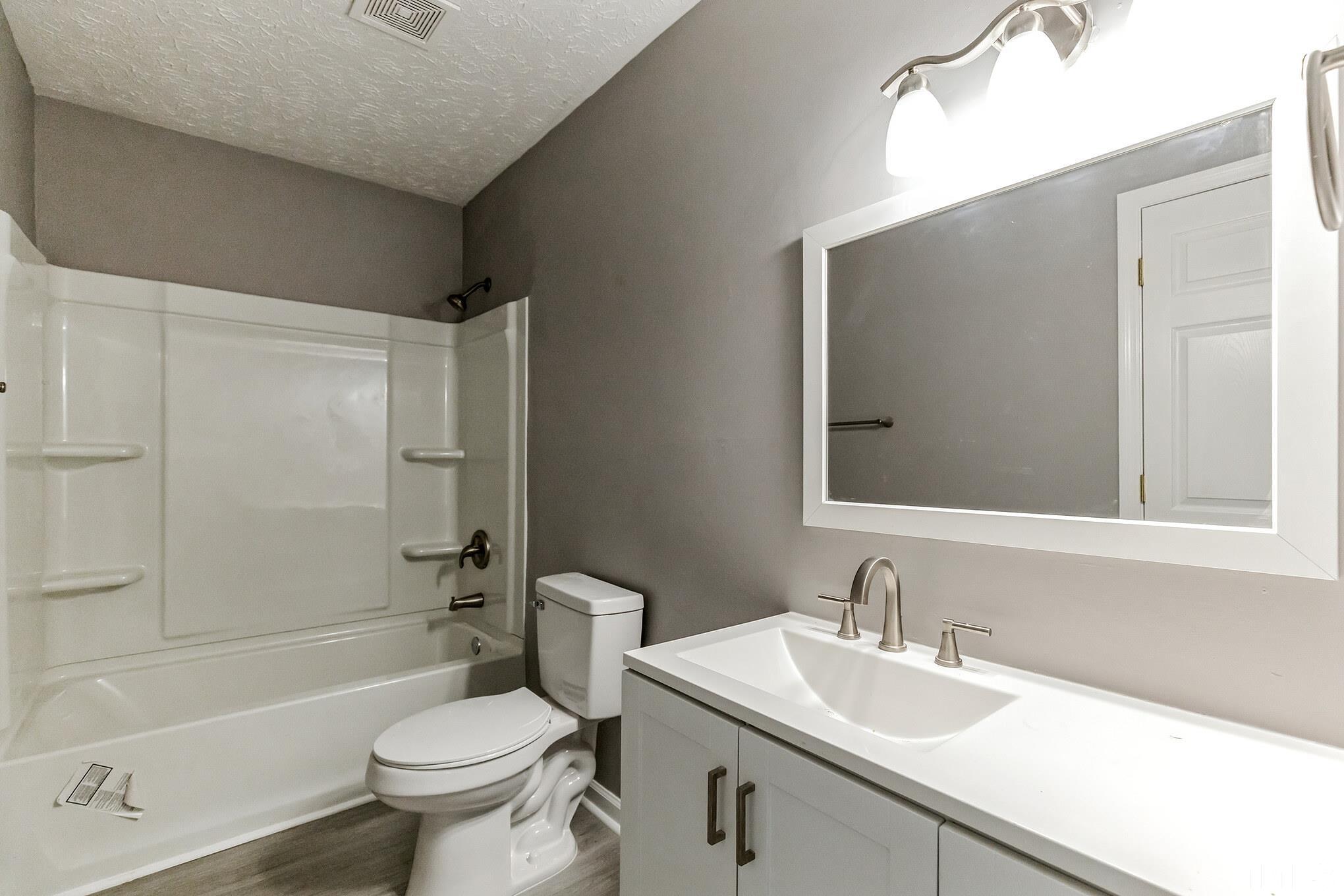 3763 Waycross Road Magnolia, NC 28453 - Photo 11 of 34 a bathroom with a sink toilet vanity and shower