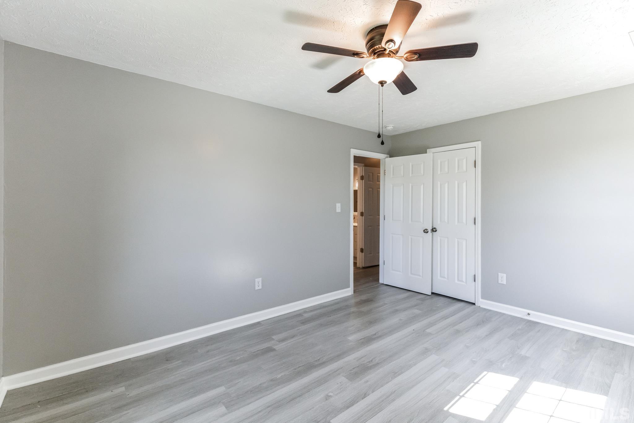 3763 Waycross Road Magnolia, NC 28453 - Photo 14 of 34 a view of a room with wooden floor and a ceiling fan