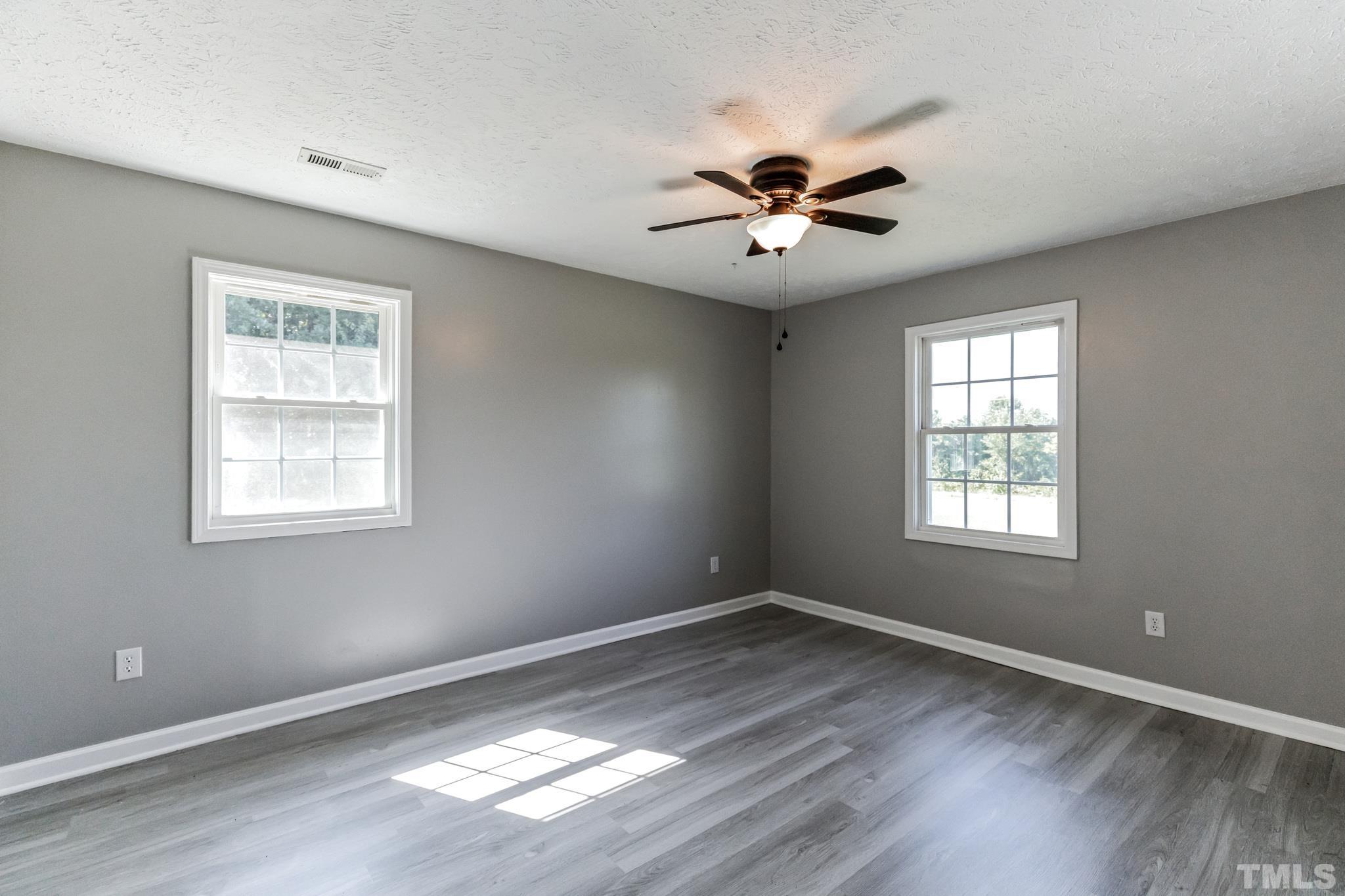 3763 Waycross Road Magnolia, NC 28453 - Photo 15 of 34 a view of a big room with wooden floor and windows in a room