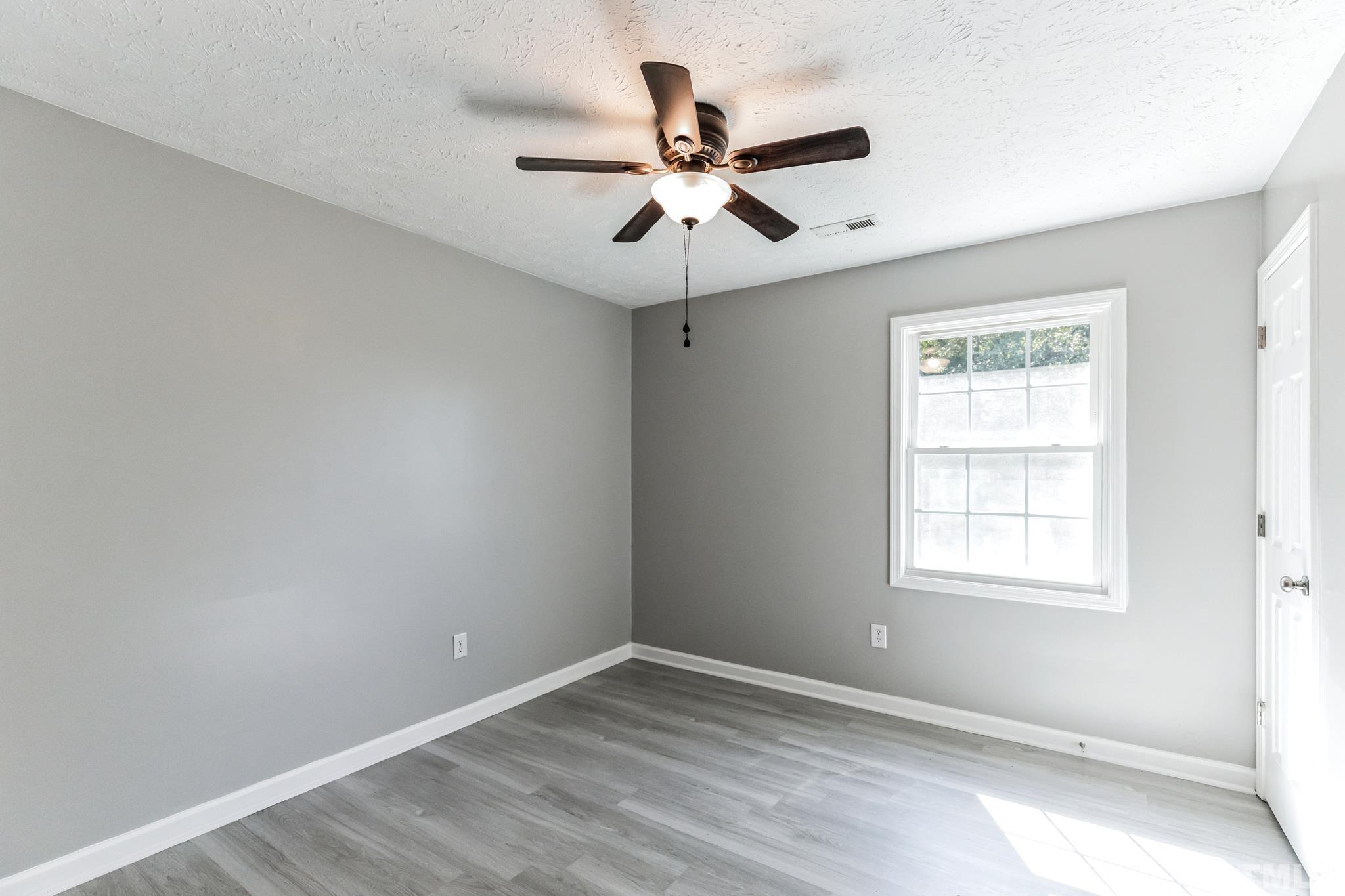 3763 Waycross Road Magnolia, NC 28453 - Photo 17 of 34 wooden floor in an empty room with a window