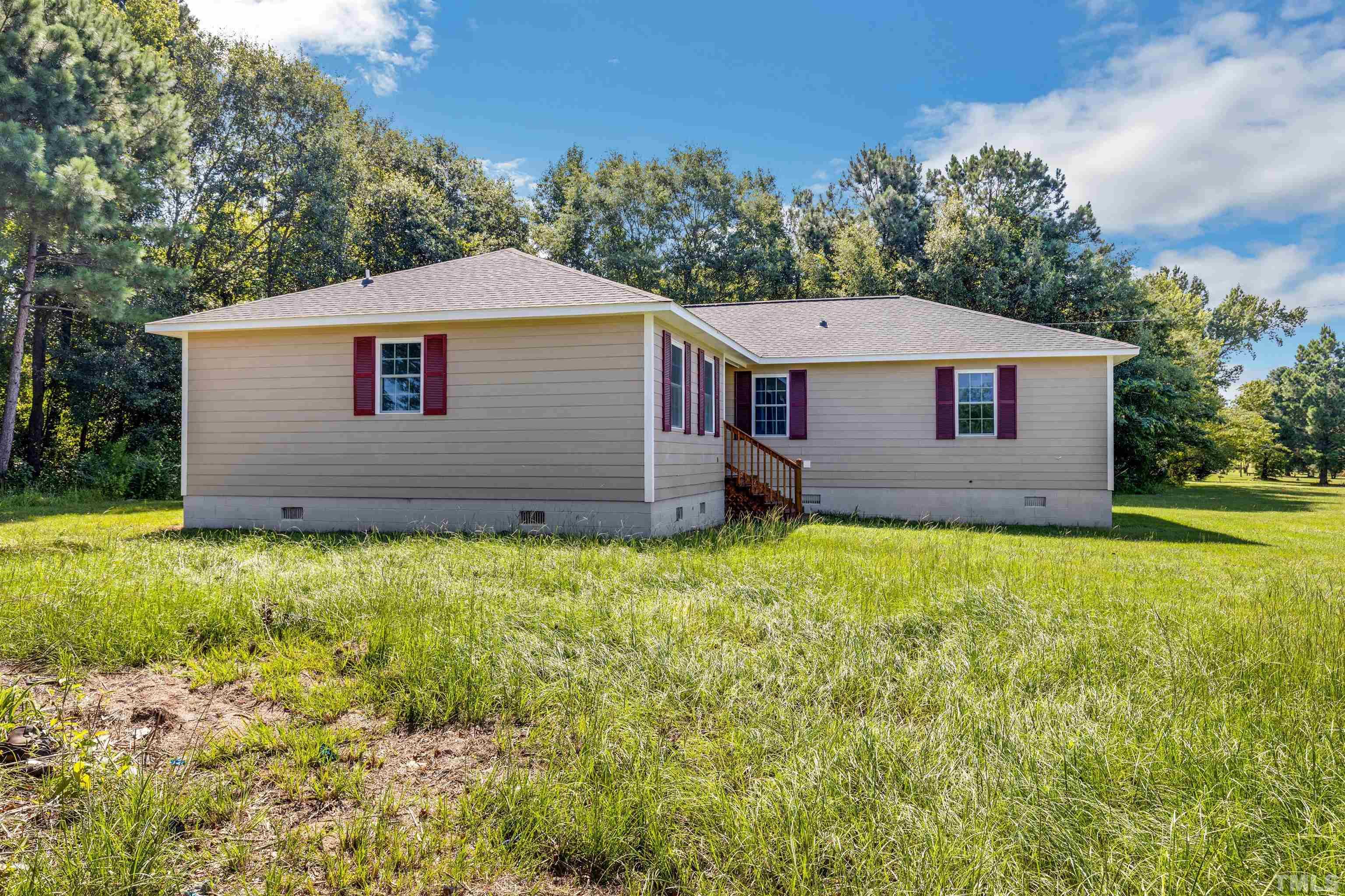 3763 Waycross Road Magnolia, NC 28453 - Photo 26 of 34 a view of a house with a yard