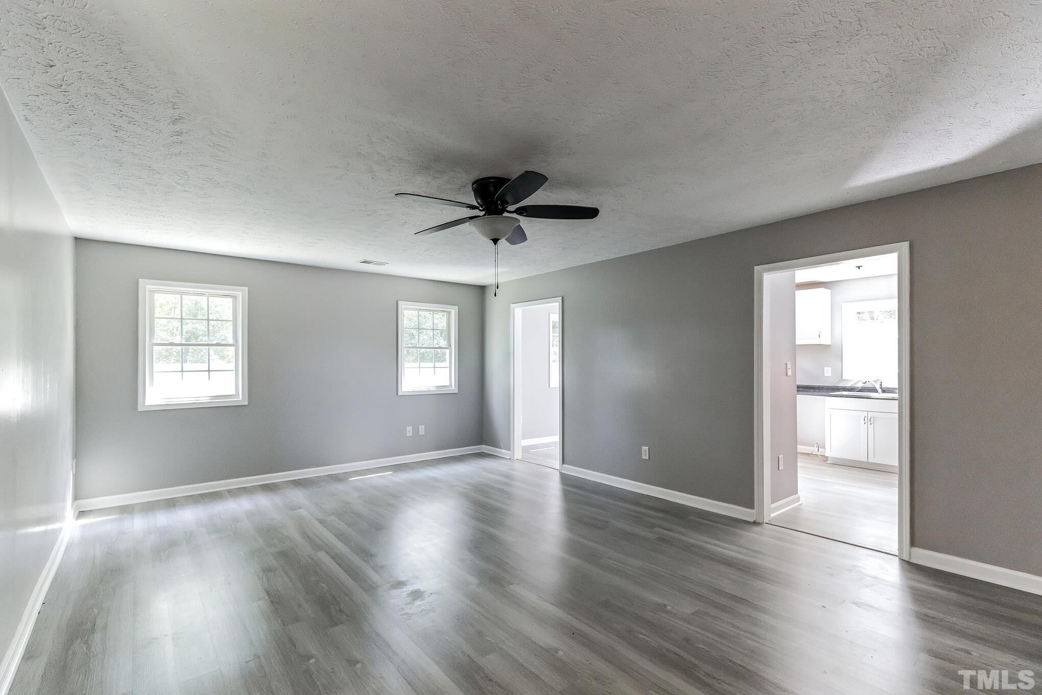 3763 Waycross Road Magnolia, NC 28453 - Photo 3 of 34 a view of an empty room with wooden floor and a window