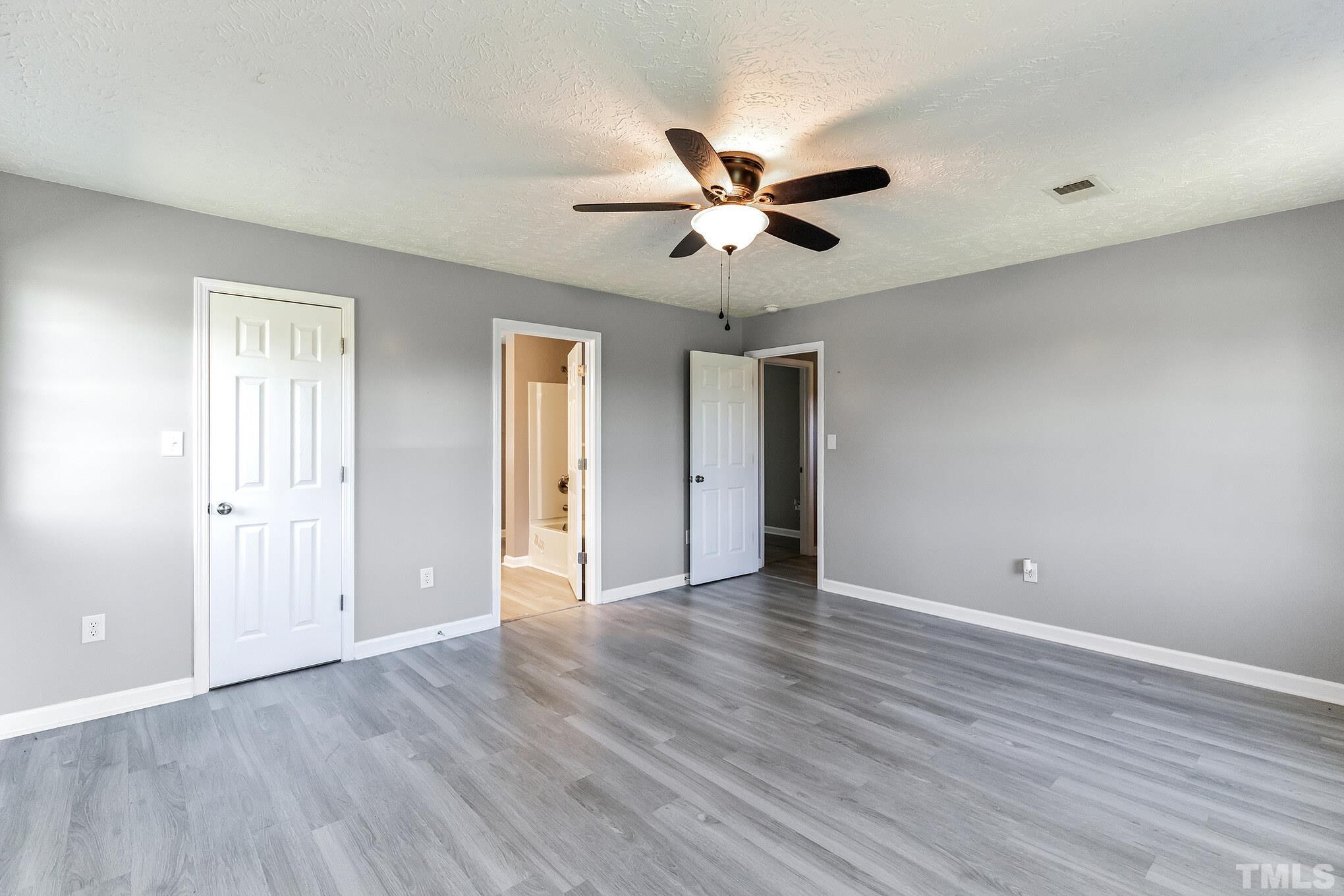 3763 Waycross Road Magnolia, NC 28453 - Photo 6 of 34 a view of an empty room with wooden floor