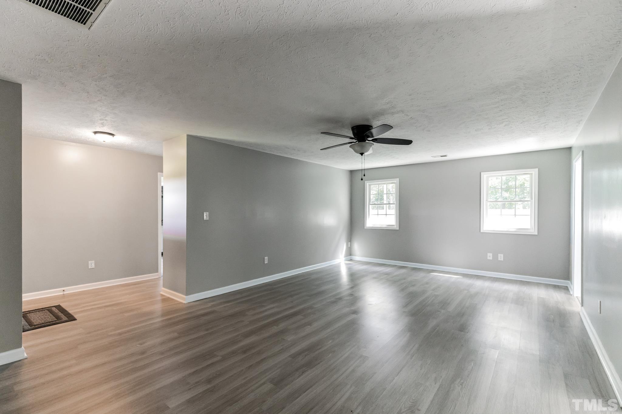 3763 Waycross Road Magnolia, NC 28453 - Photo 10 of 34 a view of an empty room with wooden floor and a window