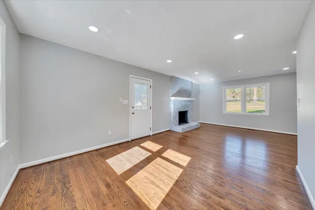 a view of an empty room and wooden floor